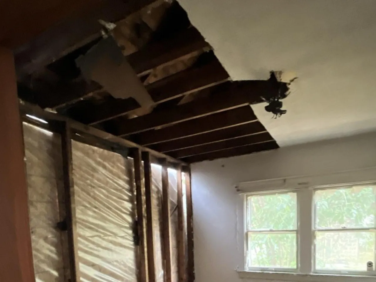 Water damage exposed to the studs and joists during mitigation in a Louisville home